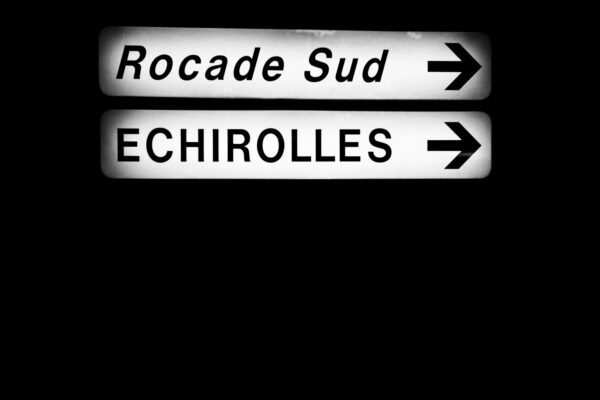 a close up of a street sign with a dark background