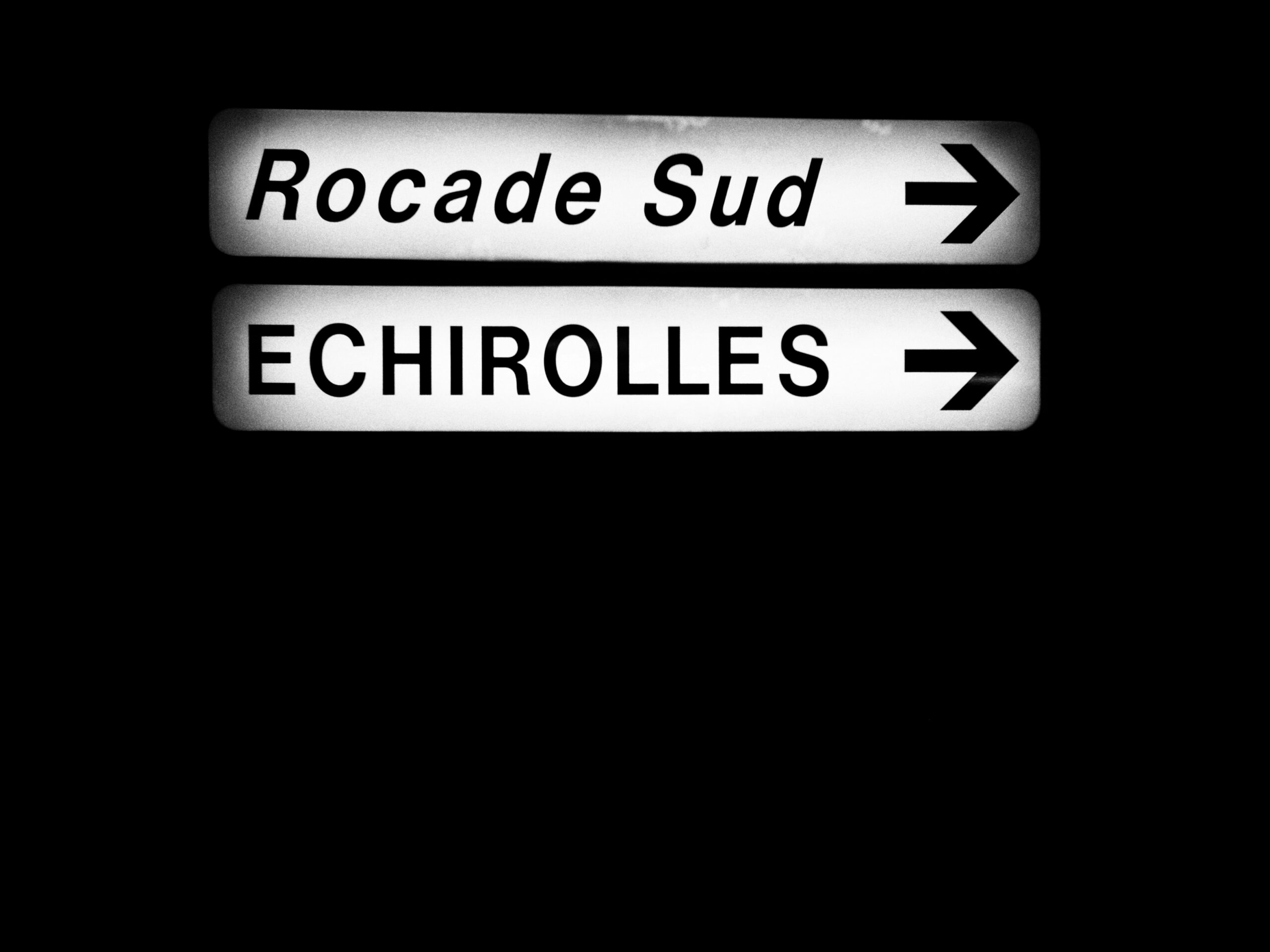 a close up of a street sign with a dark background